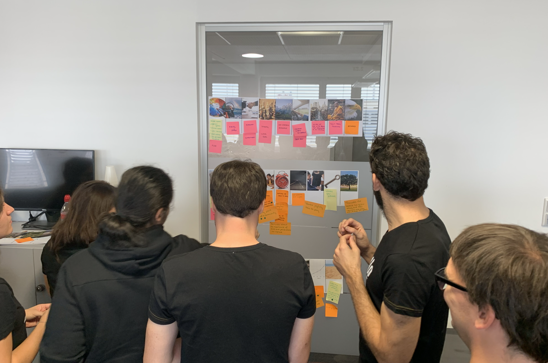 The Fretello team in a design-thinking workshop, sketching and grouping ideas around the Learn Path retention problem.