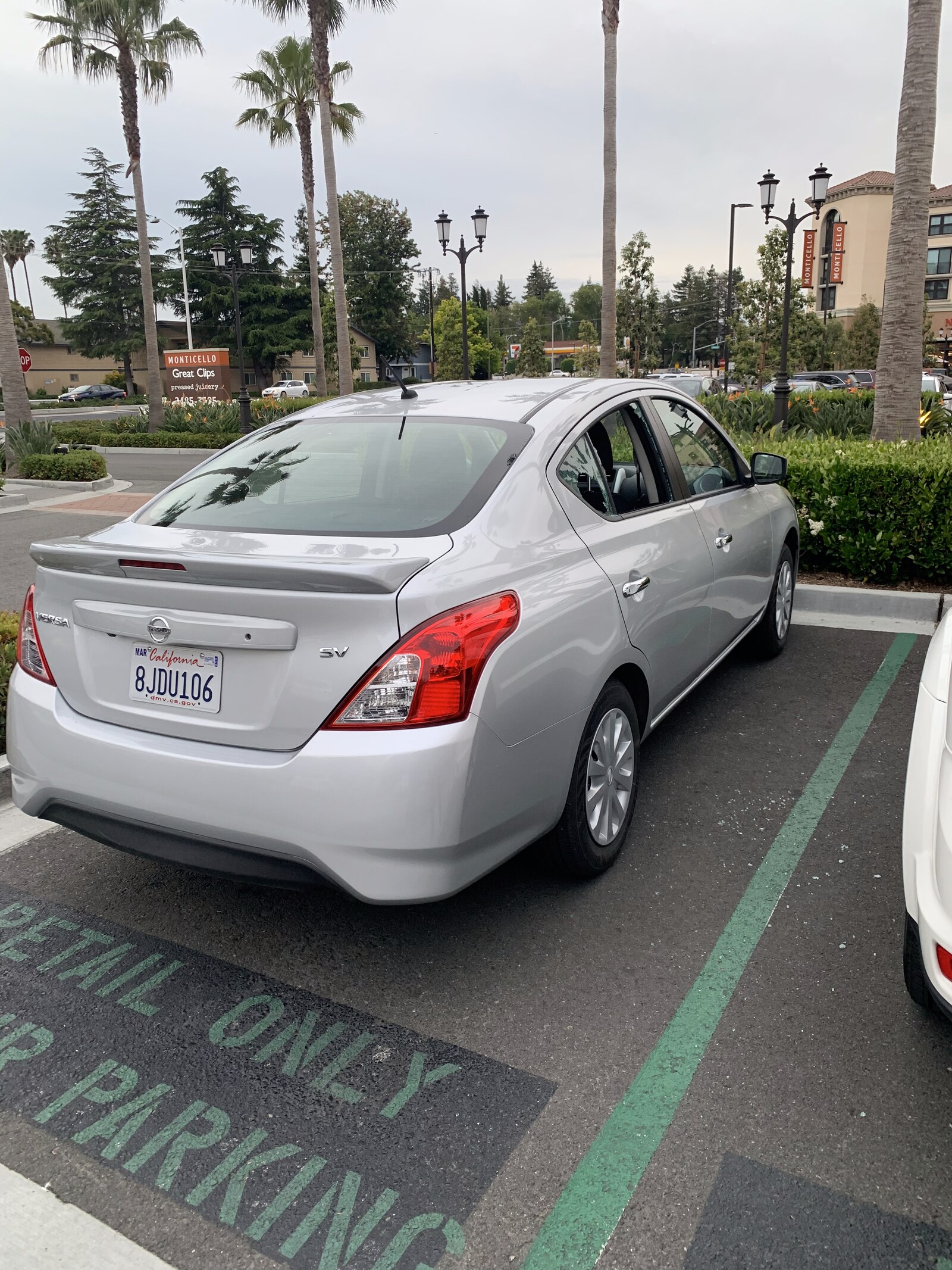 The silver rental Nissan parked in a strip-mall lot in San Jose, just before the break-in.